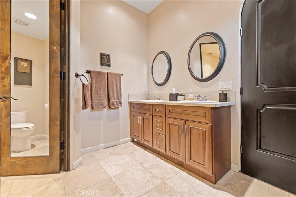 35678 Tranquil Place Cathedral City, CA 92234 - Photo 47 of 75 a bathroom with a sink a mirror a vanity and a shower