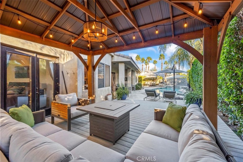 35678 Tranquil Place Cathedral City, CA 92234 - Photo 59 of 75 a living room with patio furniture and a floor to ceiling window