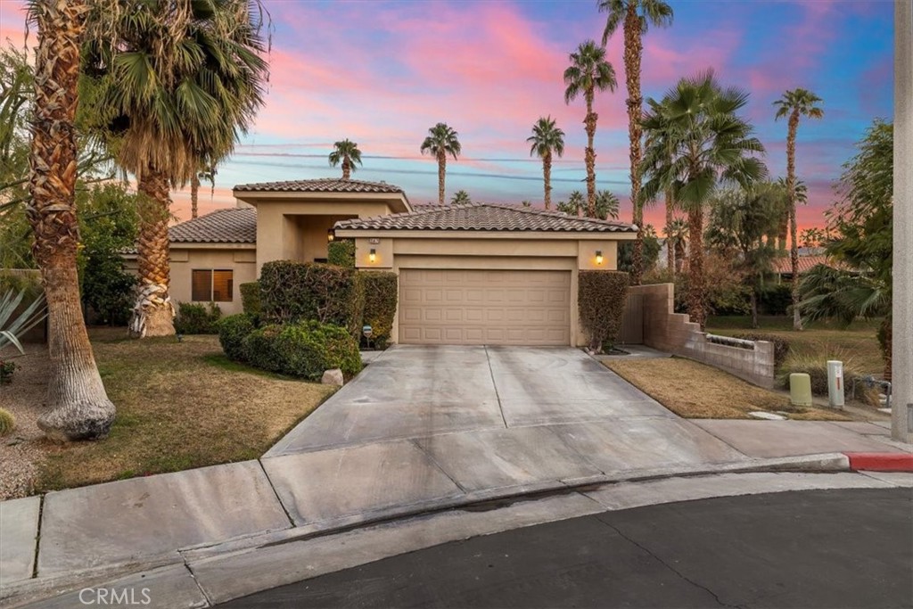 35678 Tranquil Place Cathedral City, CA 92234 - Photo 65 of 75 a front view of a house with a yard and potted plants