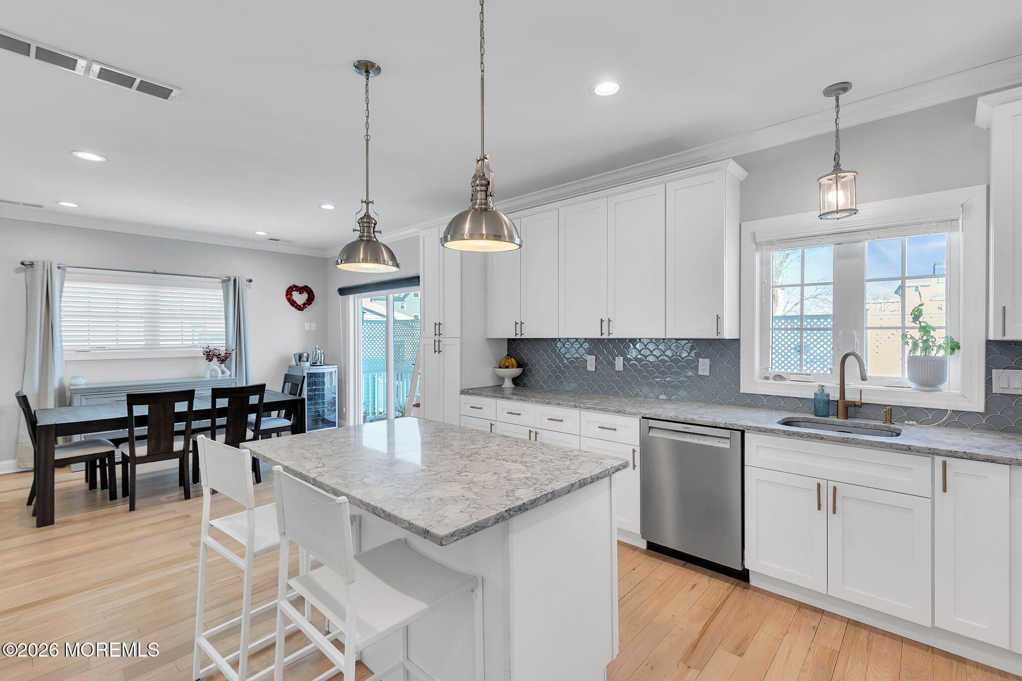 12 4th Street Highlands, NJ 07732 - Photo 11 of 41 an open kitchen with granite countertop kitchen island white cabinets and wooden floor