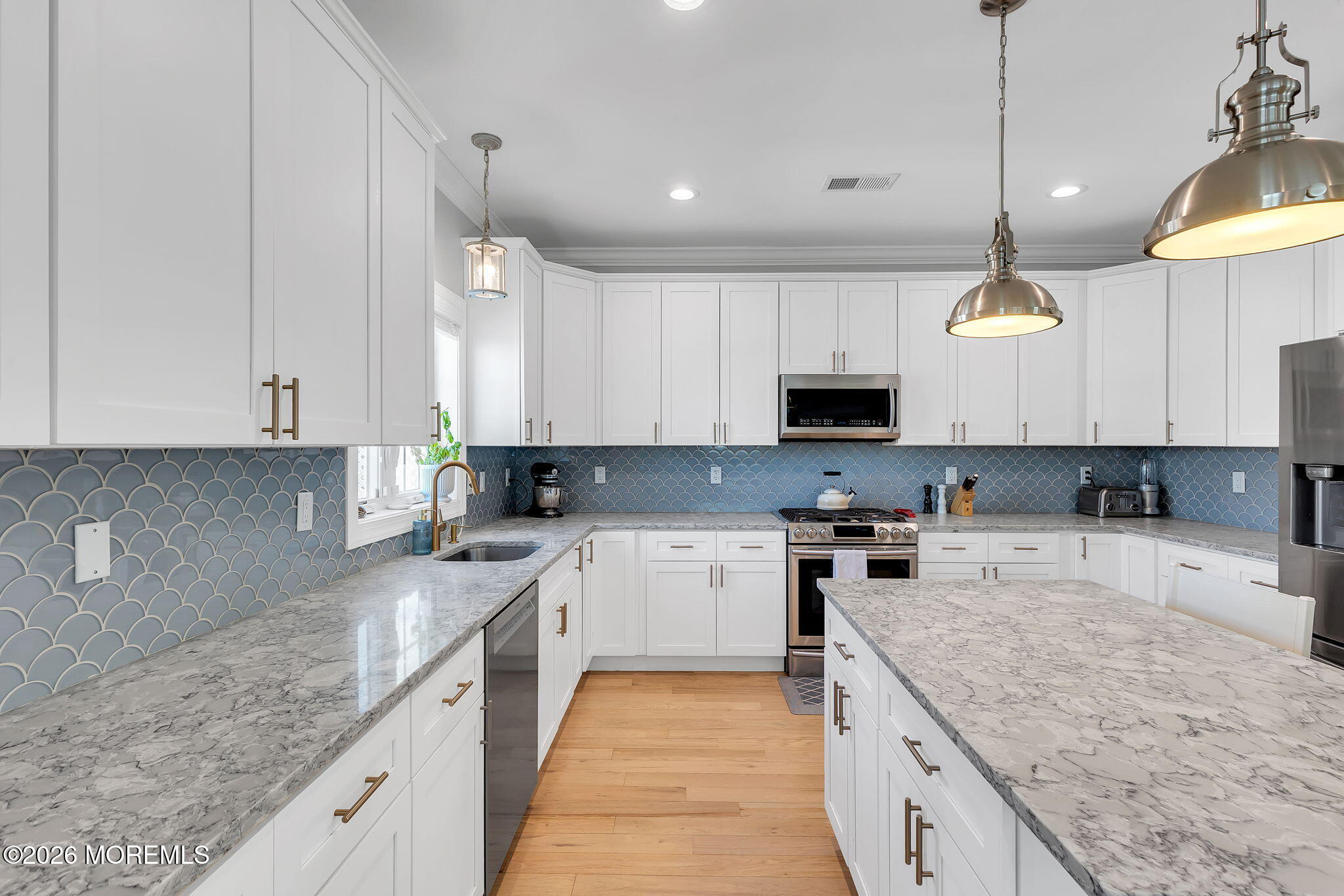 12 4th Street Highlands, NJ 07732 - Photo 18 of 41 a kitchen with granite countertop a sink a counter top space appliances and cabinets
