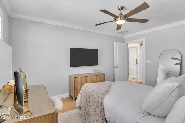 a view of room with wooden floor and flat screen tv
