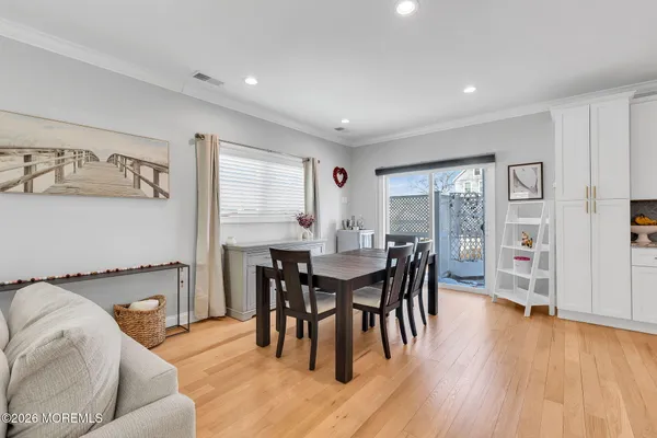 a kitchen with stainless steel appliances granite countertop a stove a refrigerator a kitchen island a table and chairs
