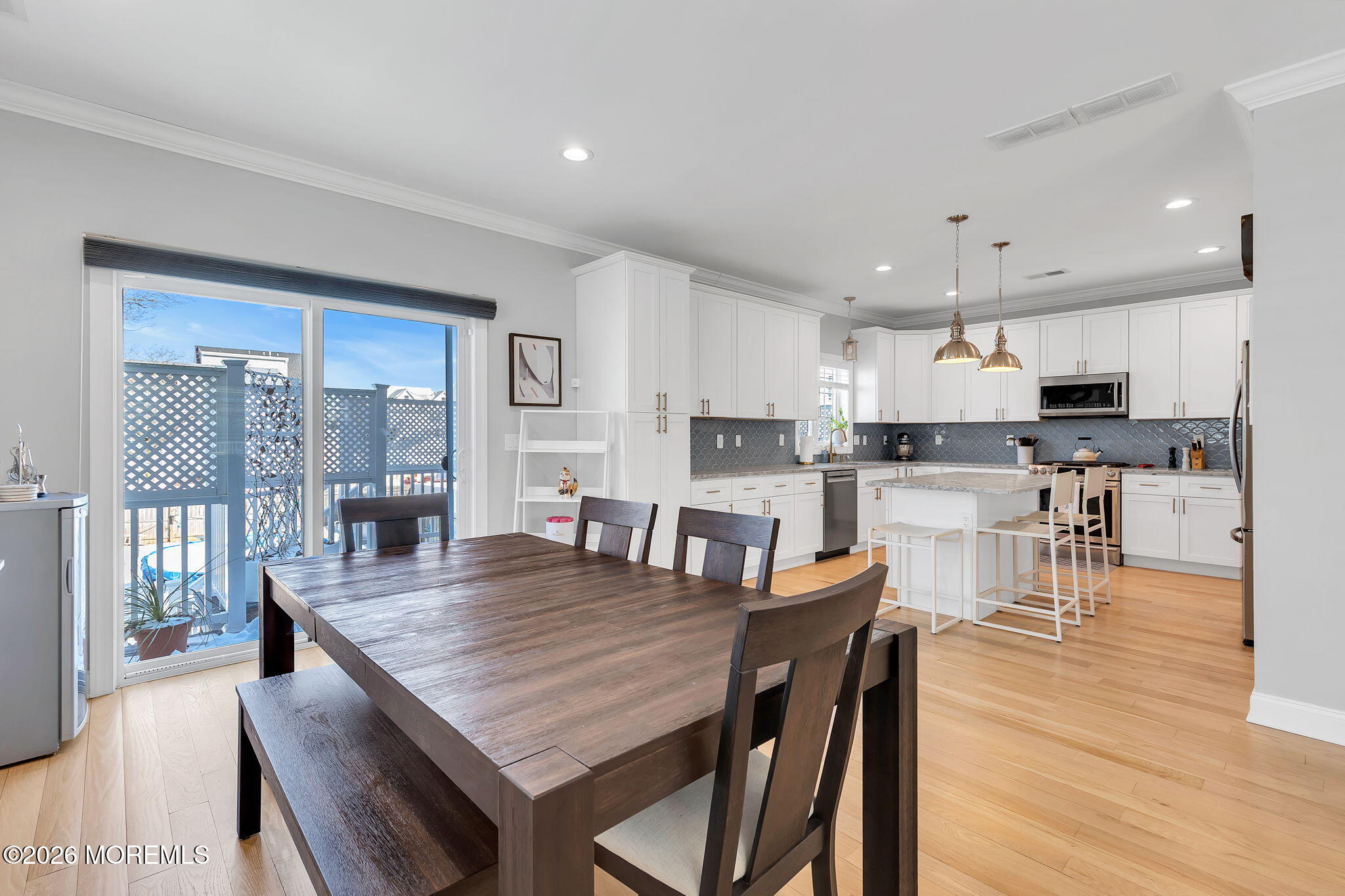 12 4th Street Highlands, NJ 07732 - Photo 10 of 41 a kitchen with stainless steel appliances granite countertop a stove a refrigerator a kitchen island a table and chairs