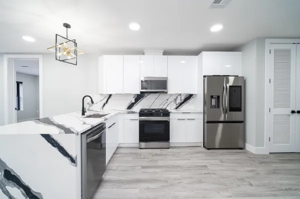 a kitchen with a stove and a refrigerator