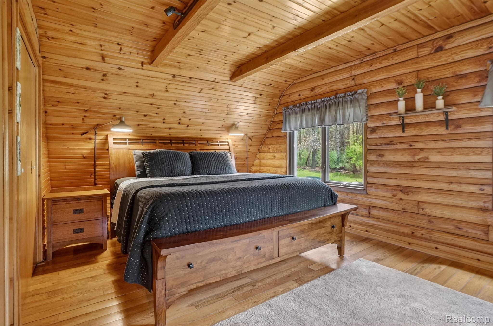 2997 Brighton Road Howell, MI 48843 - Photo 15 of 30 Bedroom with light wood-type flooring, rustic walls, wooden ceiling, and lofted ceiling with beams