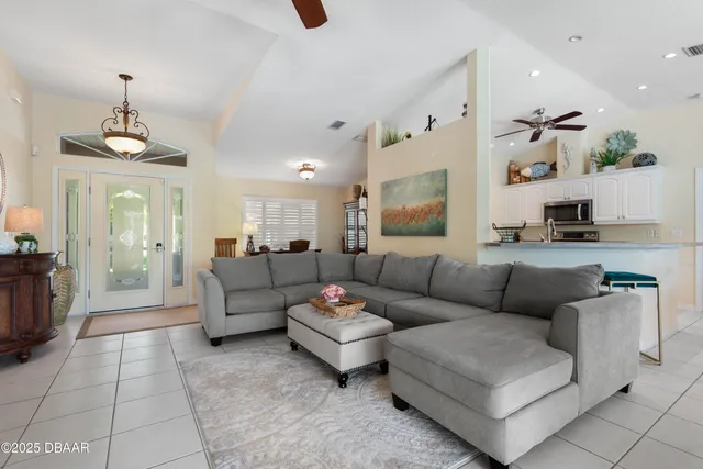 a kitchen with stainless steel appliances kitchen island granite countertop a refrigerator and a sink