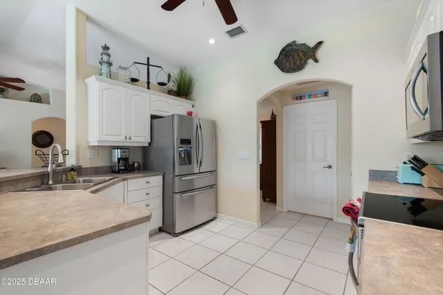 a living room with a bed furniture and a flat screen tv