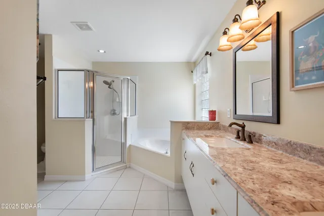 a bedroom with a bed and a night stand