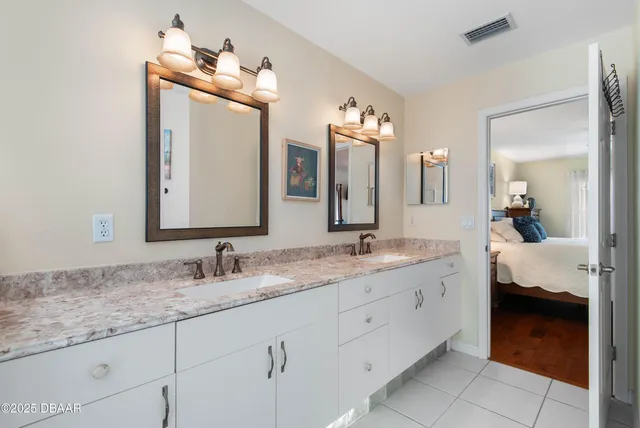 a bedroom with two beds and window