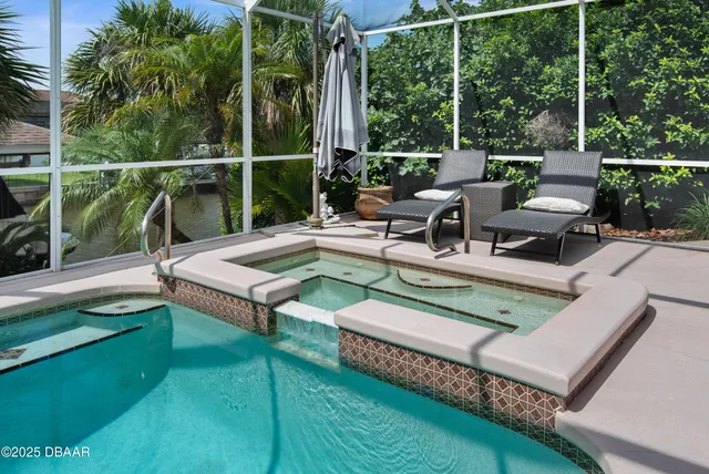 an aerial view of a house with a garden and lake view