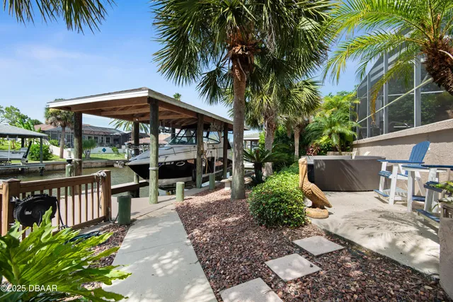 a view of a house with swimming pool and sitting area