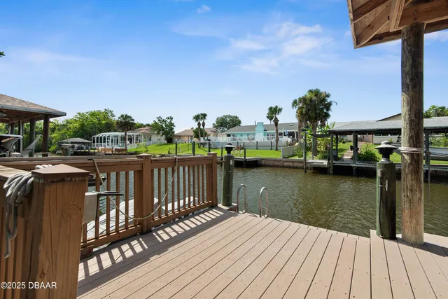an aerial view of a house with a garden and lake view