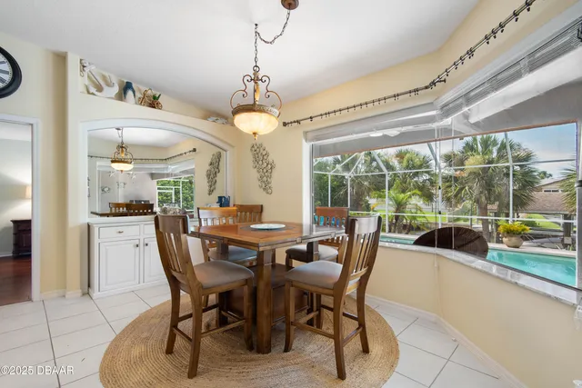 an aerial view of a city with lots of residential buildings ocean and mountain view in back
