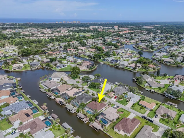 a front view of a house with a garden and trees