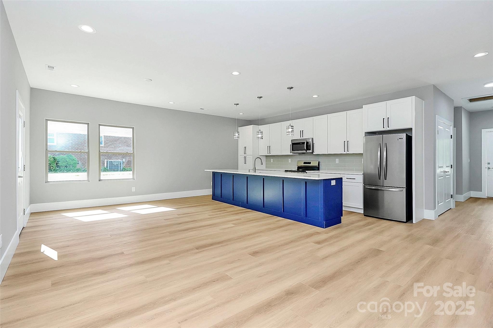5516 Old York Road Rock Hill, SC 29732 - Photo 10 of 38 a kitchen with stainless steel appliances kitchen island granite countertop a refrigerator oven a sink with dishwasher and white cabinets