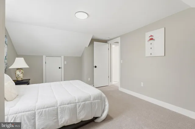 a bedroom with a bed and a painting