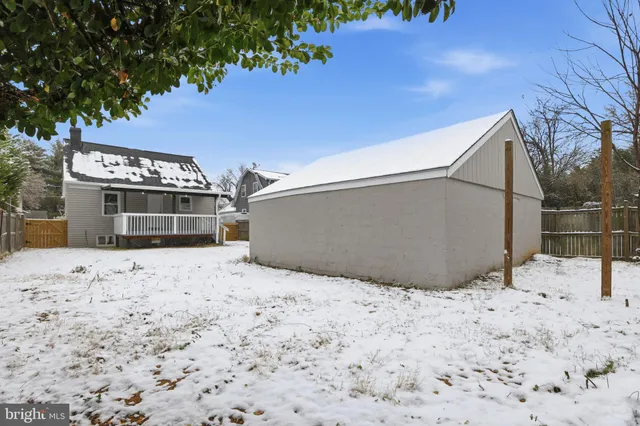 a view of a backyard of a house with wooden fence