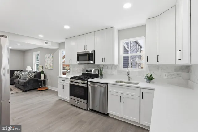 a kitchen with a sink stove and cabinets