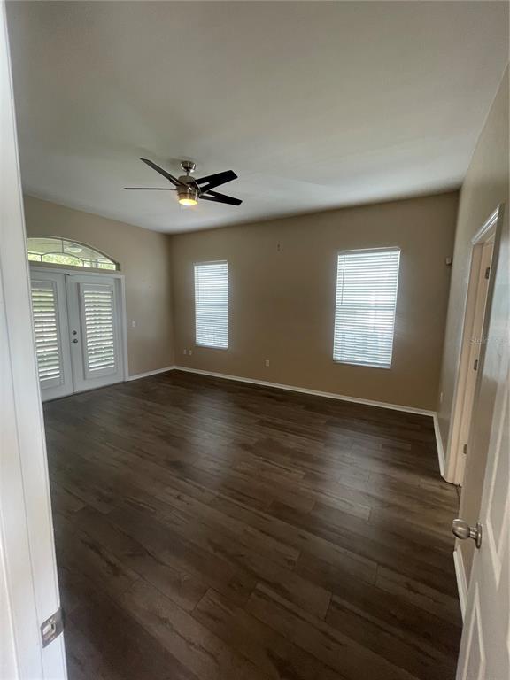 2244 Northwest 101st Street Gainesville, FL 32606 - Photo 13 of 39 an empty room with wooden floor and windows