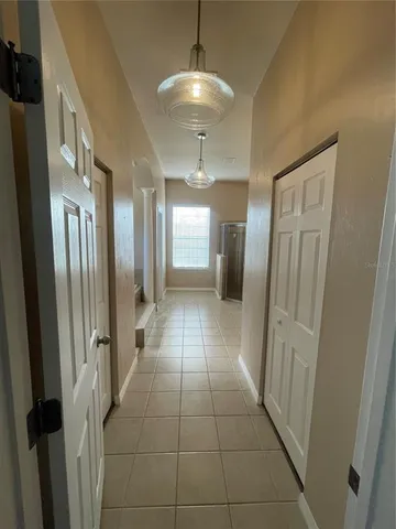 a hallway view with staircase