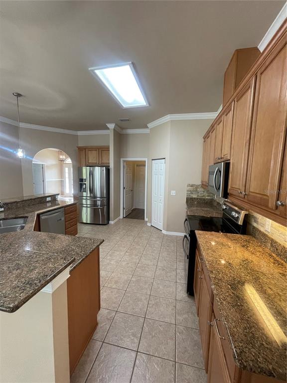2244 Northwest 101st Street Gainesville, FL 32606 - Photo 19 of 39 a kitchen with a sink a counter top space and cabinets