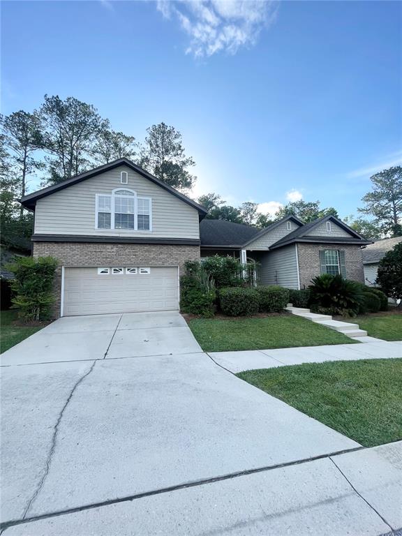 2244 Northwest 101st Street Gainesville, FL 32606 - Photo 2 of 39 a front view of a house with a yard