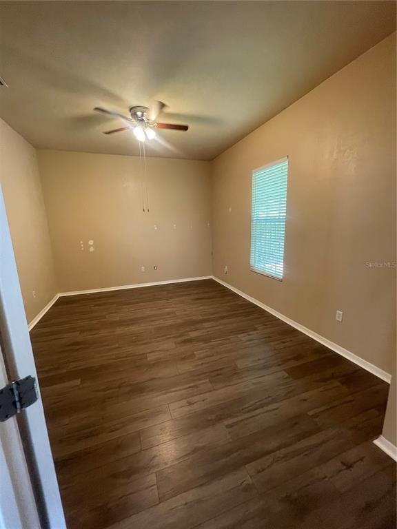 2244 Northwest 101st Street Gainesville, FL 32606 - Photo 24 of 39 a view of an empty room with wooden floor and a ceiling fan