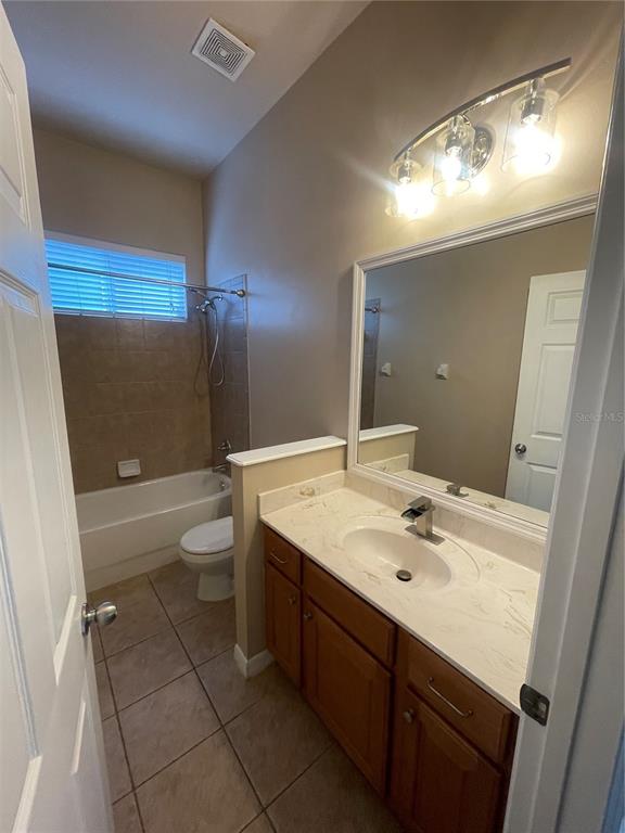 2244 Northwest 101st Street Gainesville, FL 32606 - Photo 28 of 39 a bathroom with a sink a toilet a mirror and shower