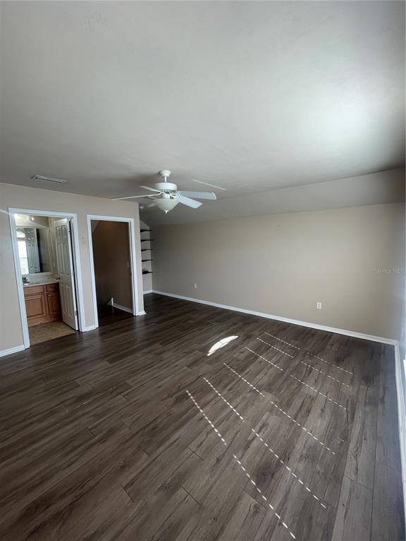 2244 Northwest 101st Street Gainesville, FL 32606 - Photo 32 of 39 an empty room with wooden floor and fireplace