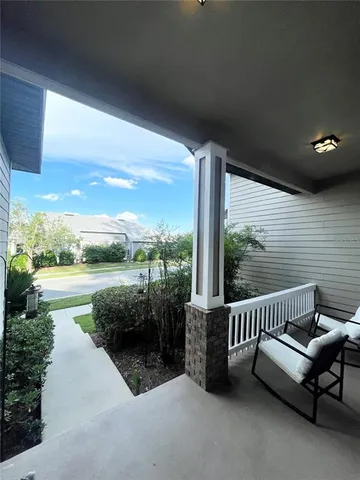 a view of a patio with a table and chairs