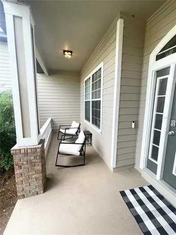 a balcony with furniture and a window