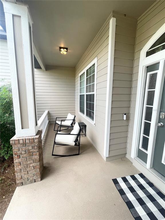 2244 Northwest 101st Street Gainesville, FL 32606 - Photo 7 of 39 a balcony with furniture and a window
