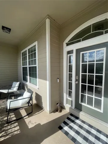 a building outdoor space with patio furniture and windows