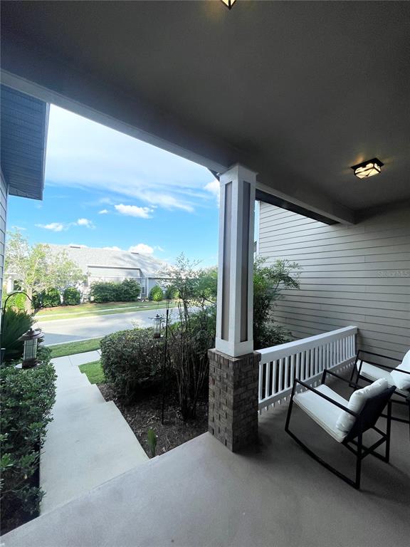 2244 Northwest 101st Street Gainesville, FL 32606 - Photo 10 of 39 a view of a patio with a table chairs and a floor to ceiling window