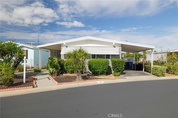 a view of a patio with a table and chairs under an umbrella