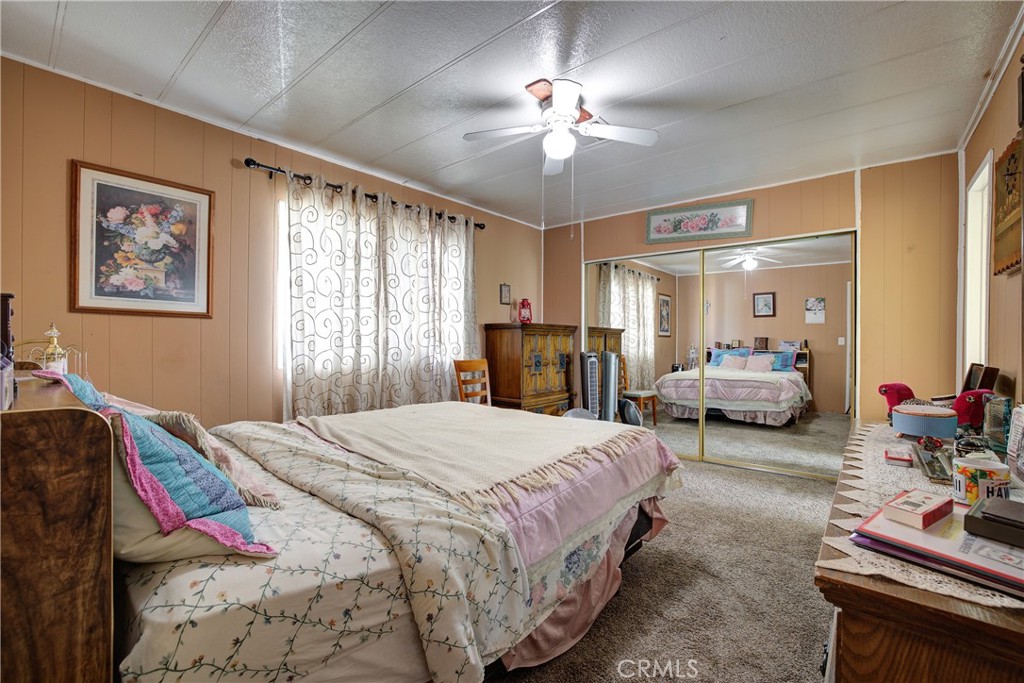 3700 Buchanan Street, Unit 105 Corona, CA 92503 - Photo 16 of 30 a bedroom with bed and a chandelier