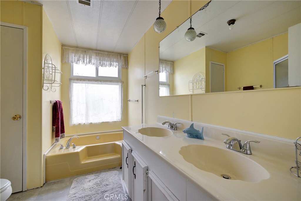 3700 Buchanan Street, Unit 105 Corona, CA 92503 - Photo 18 of 30 a bathroom with a tub sink and mirror