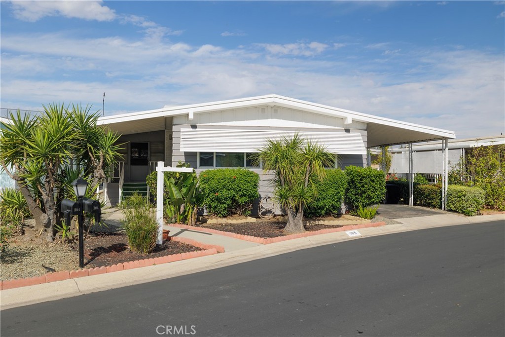 3700 Buchanan Street, Unit 105 Corona, CA 92503 - Photo 2 of 30 a front view of a house with a yard and potted plants