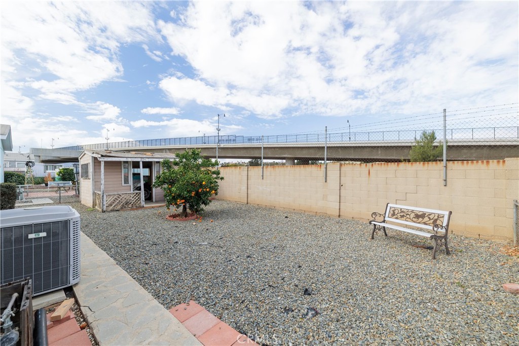 3700 Buchanan Street, Unit 105 Corona, CA 92503 - Photo 27 of 30 a view of house with lake and outdoor seating