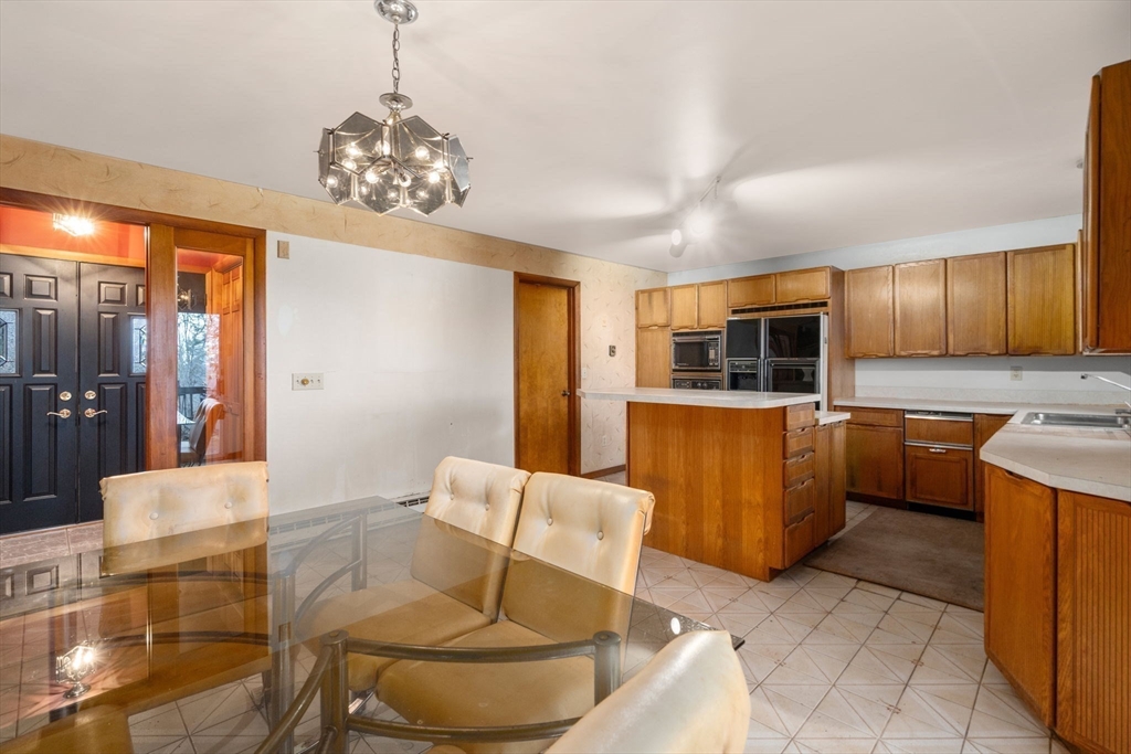 274 Brookfield Road Sturbridge, MA 01518 - Photo 19 of 30 a living room with stainless steel appliances kitchen island granite countertop furniture and a kitchen view
