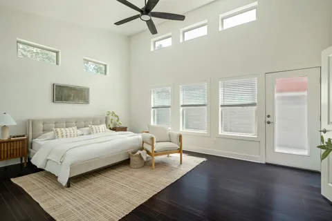 a bedroom with a bed wooden floor and window