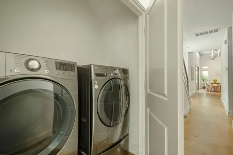 a view of a hallway with washer and dryer