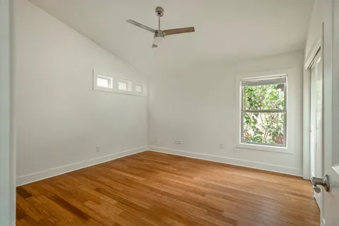 wooden floor in an empty room with a window