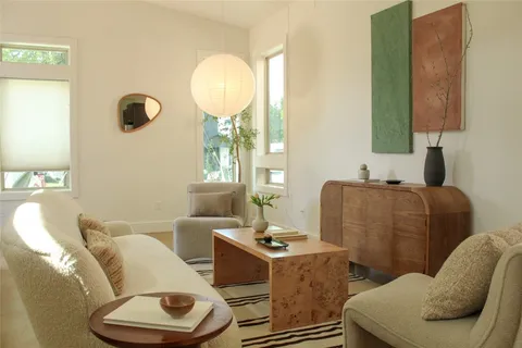 a living room with furniture and a large mirror