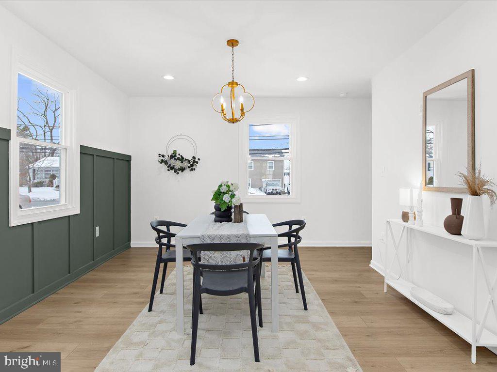 313 North Hammonds Ferry Road Linthicum Heights, MD 21090 - Photo 11 of 39 a view of a dining room with furniture and chandelier