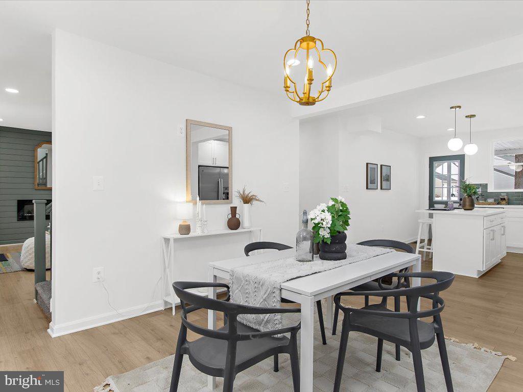 313 North Hammonds Ferry Road Linthicum Heights, MD 21090 - Photo 16 of 39 a view of a dining room with furniture and chandelier