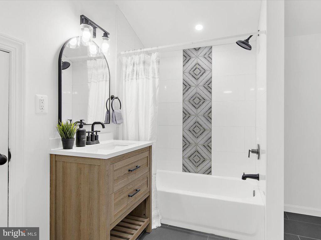 313 North Hammonds Ferry Road Linthicum Heights, MD 21090 - Photo 17 of 39 a bathroom with a bathtub and a sink