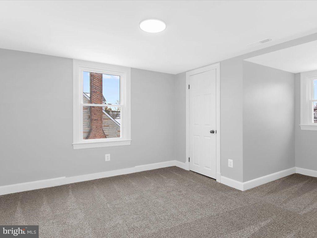 313 North Hammonds Ferry Road Linthicum Heights, MD 21090 - Photo 18 of 39 an empty room with windows and closet