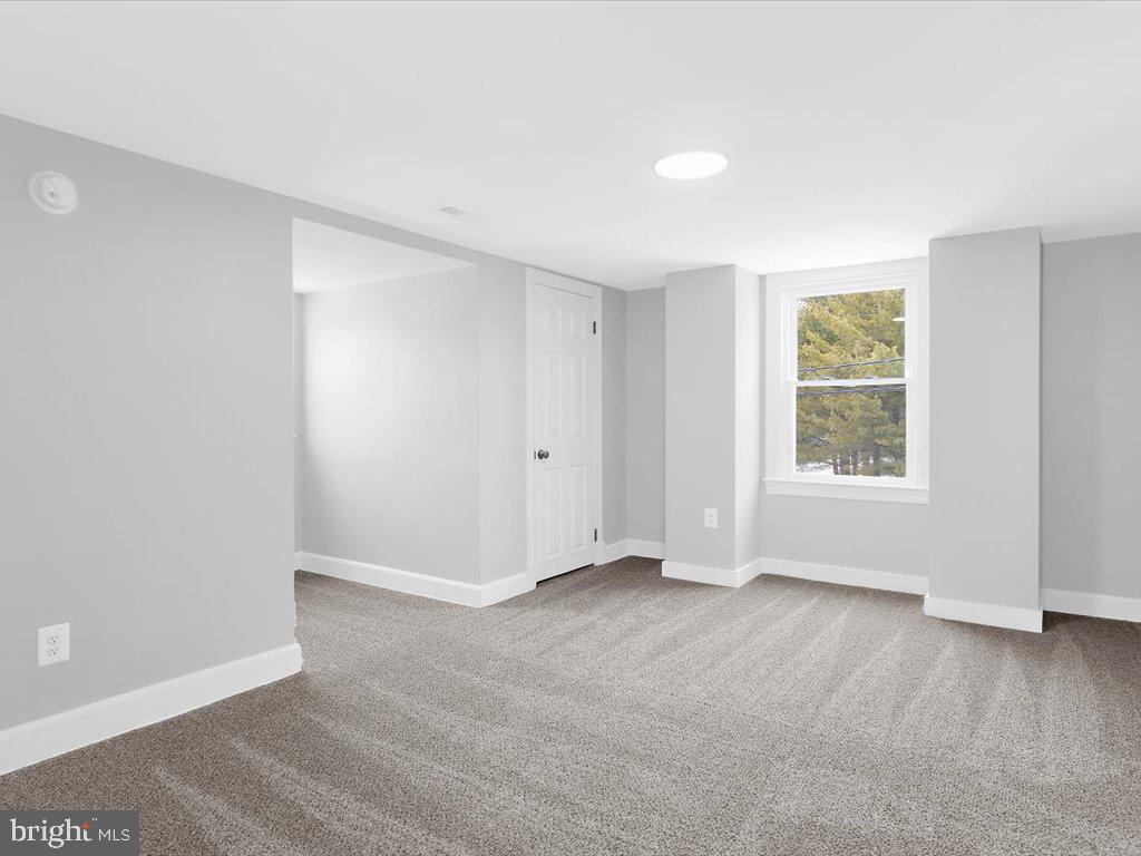 313 North Hammonds Ferry Road Linthicum Heights, MD 21090 - Photo 21 of 39 an empty room with wooden floor and windows